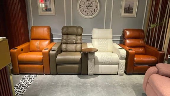 A row of theatre recliners in mixed leather colours